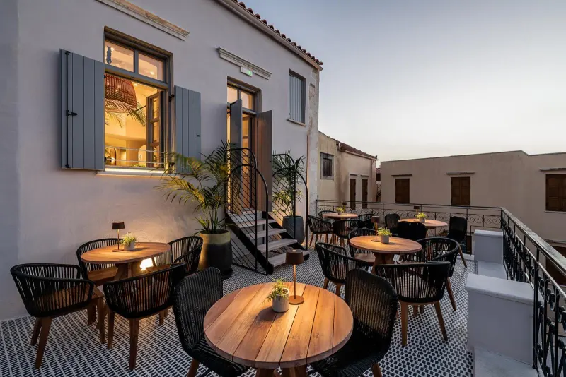 Rooftop terrace with dining tables at dusk