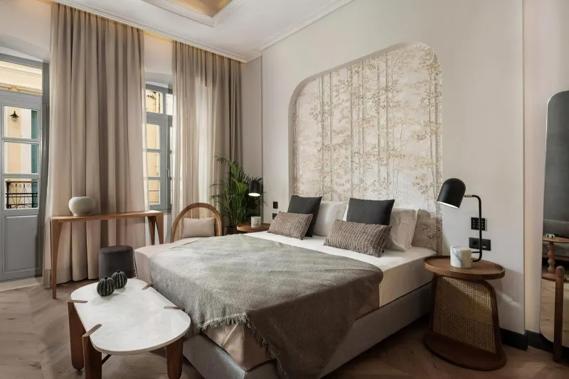 Bedroom with floral headboard and curtains