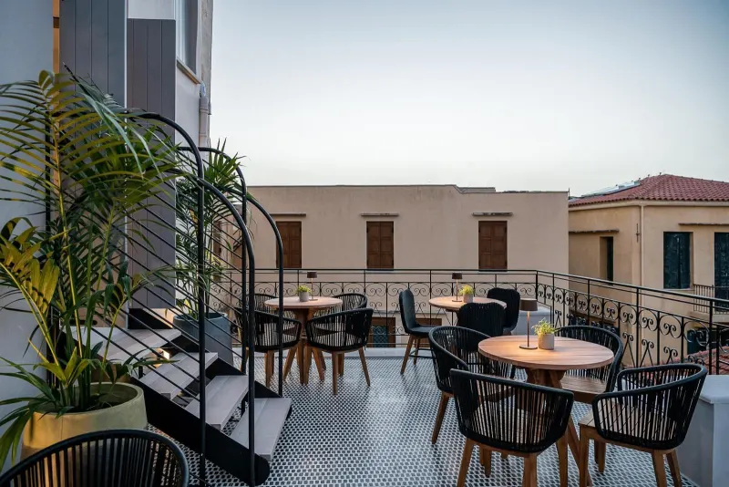 Rooftop terrace seating with plants at dusk