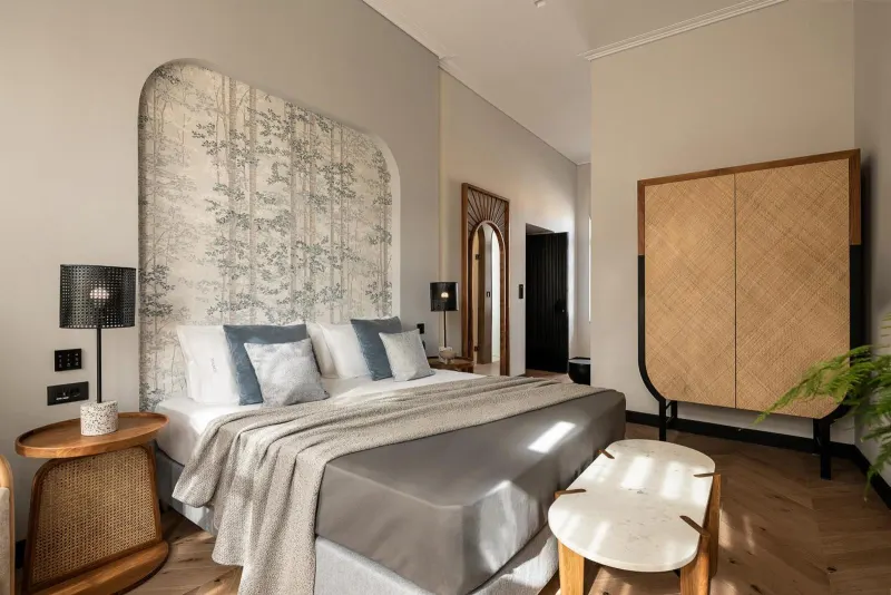 Bedroom with patterned headboard and rattan wardrobe