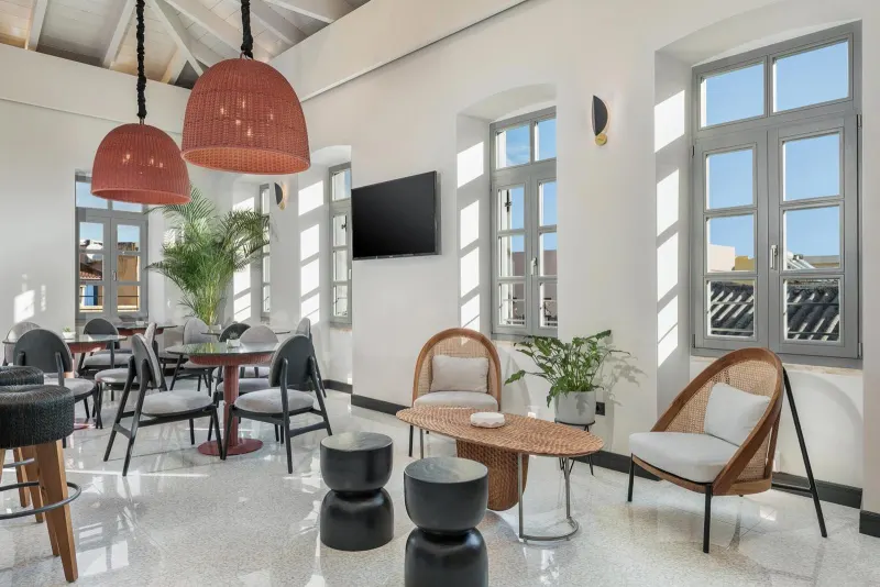 Bright lounge with arched windows and rattan lamps