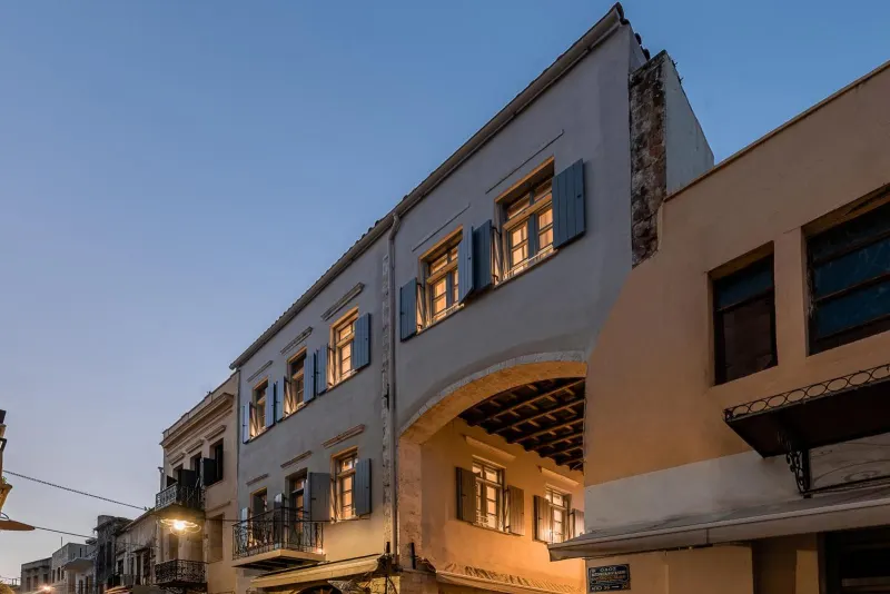 Historic hotel facade at dusk with archway