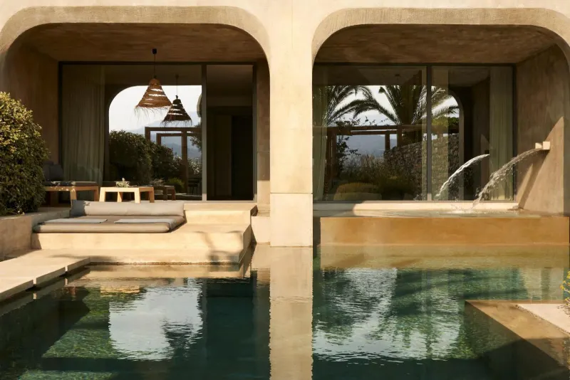 Private villa pool with arched walkway and fountain