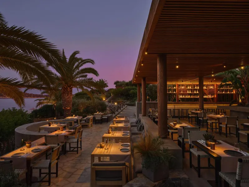 Outdoor restaurant terrace with sea view at dusk