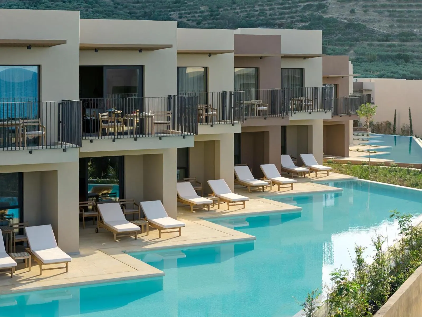 Poolside villas with loungers and balconies