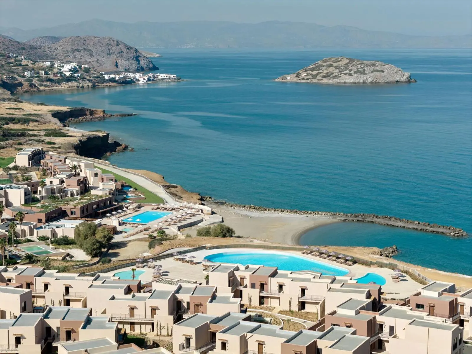 Aerial view of resort pools and bay with island