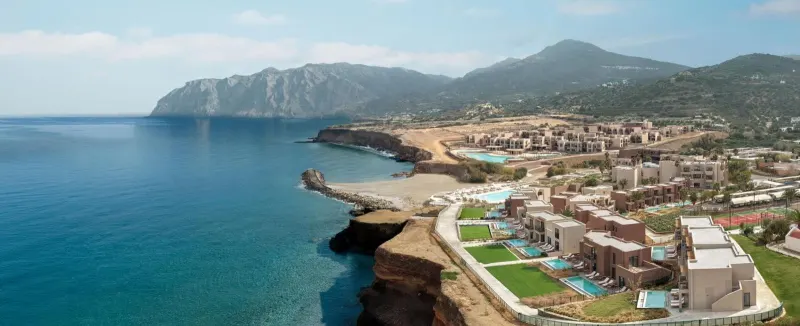 Aerial view of coastal resort with mountains and sea