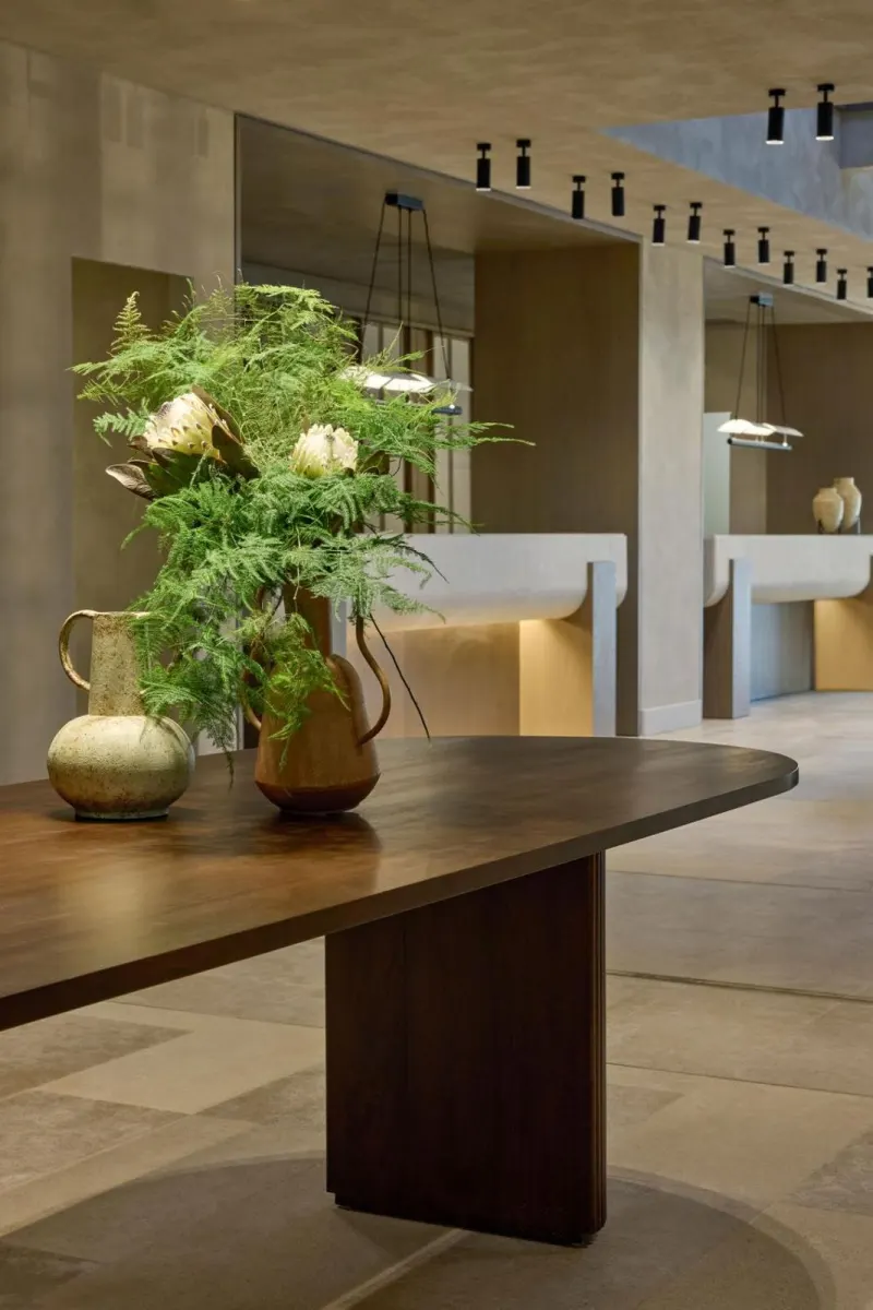 Wooden table with flowers in modern lobby