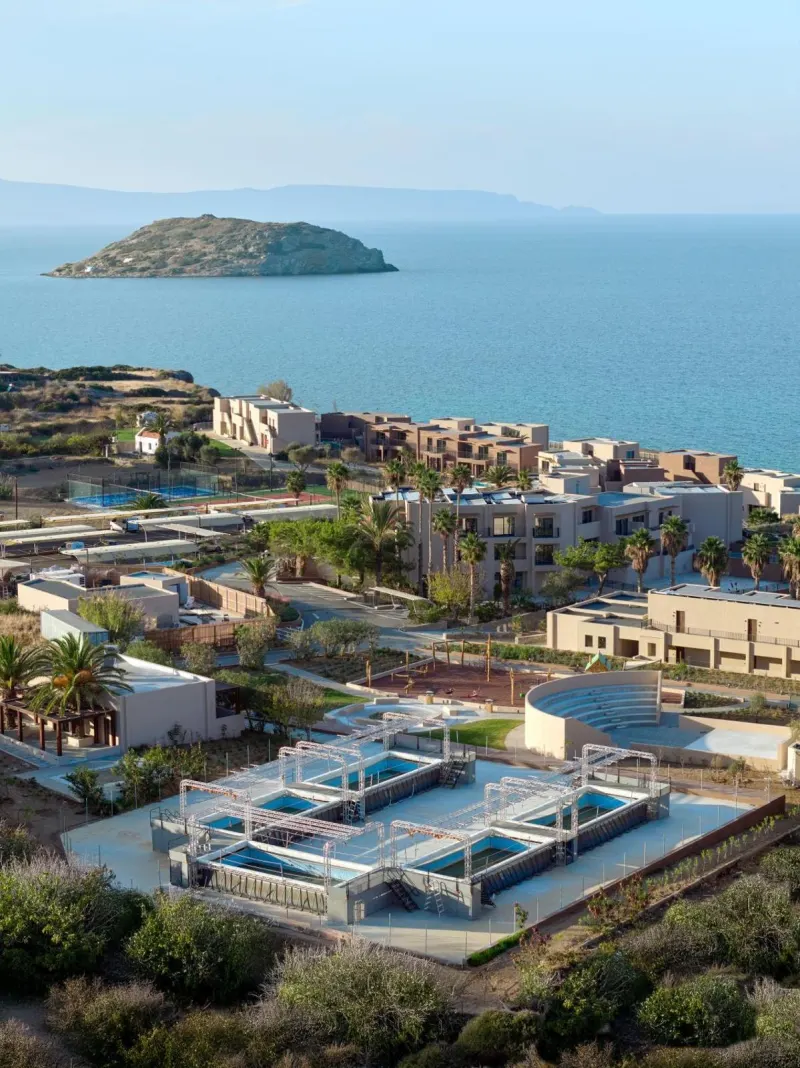 Aerial view of resort pools and gardens by sea