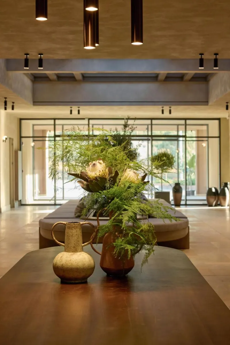 Lobby table with flower arrangement and vases