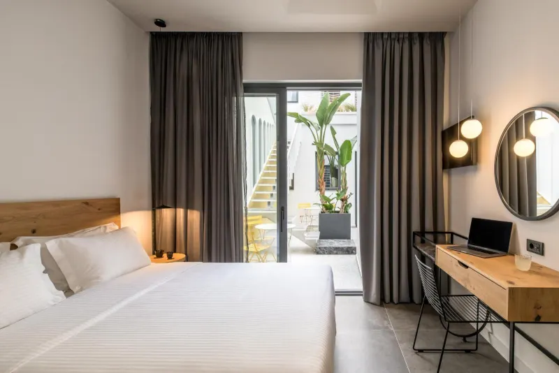 Bedroom with curtains open to private terrace