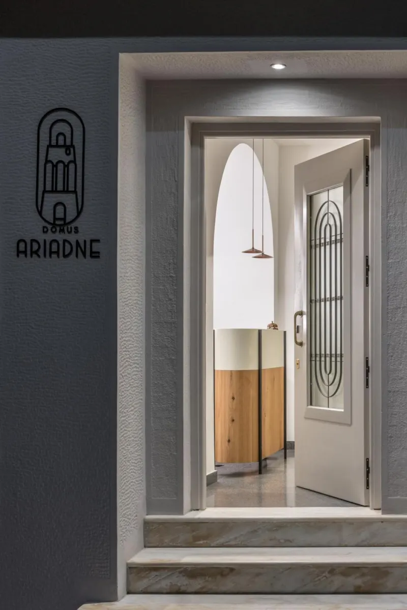 Hotel entrance with logo and arched mirror