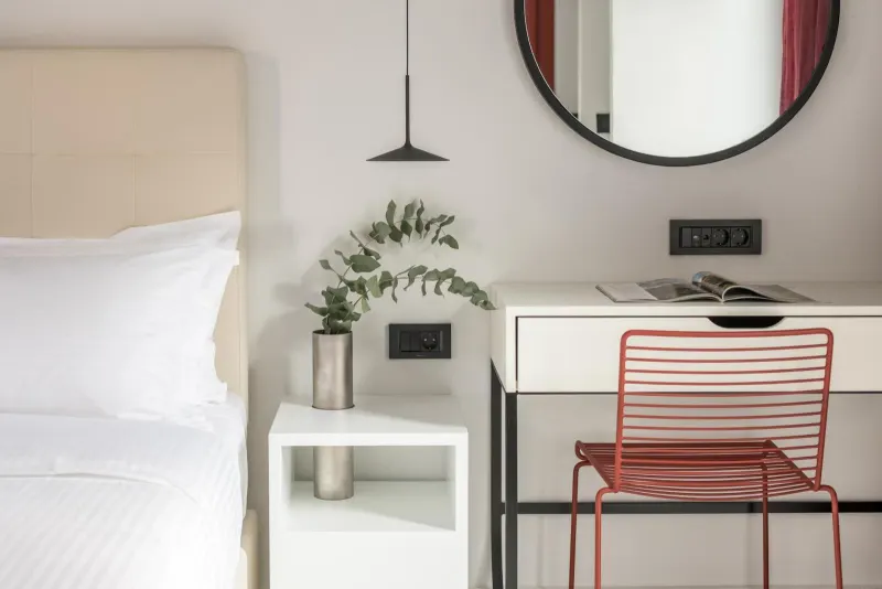 Bedside table with mirror and red chair