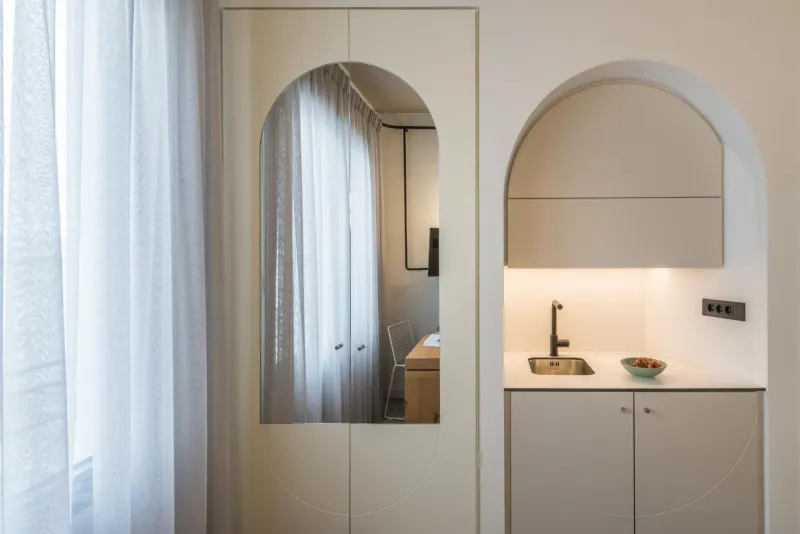 Arched mirror beside kitchenette nook