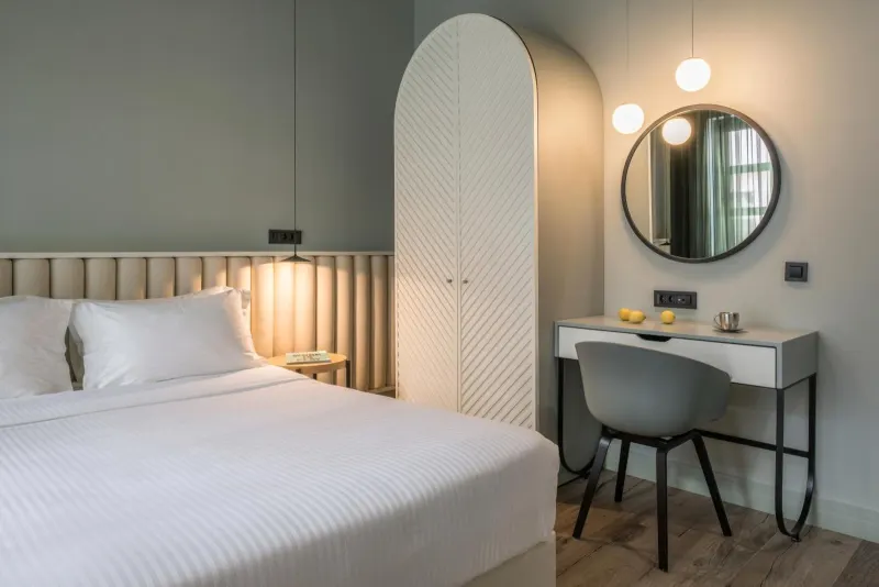 Bedroom with arched wardrobe and pendant lights