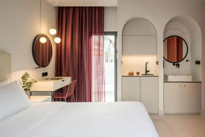Bedroom with arched mirrors and kitchenette