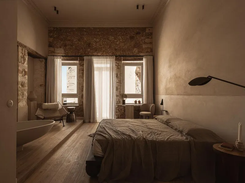 Bedroom with stone walls and soft lighting