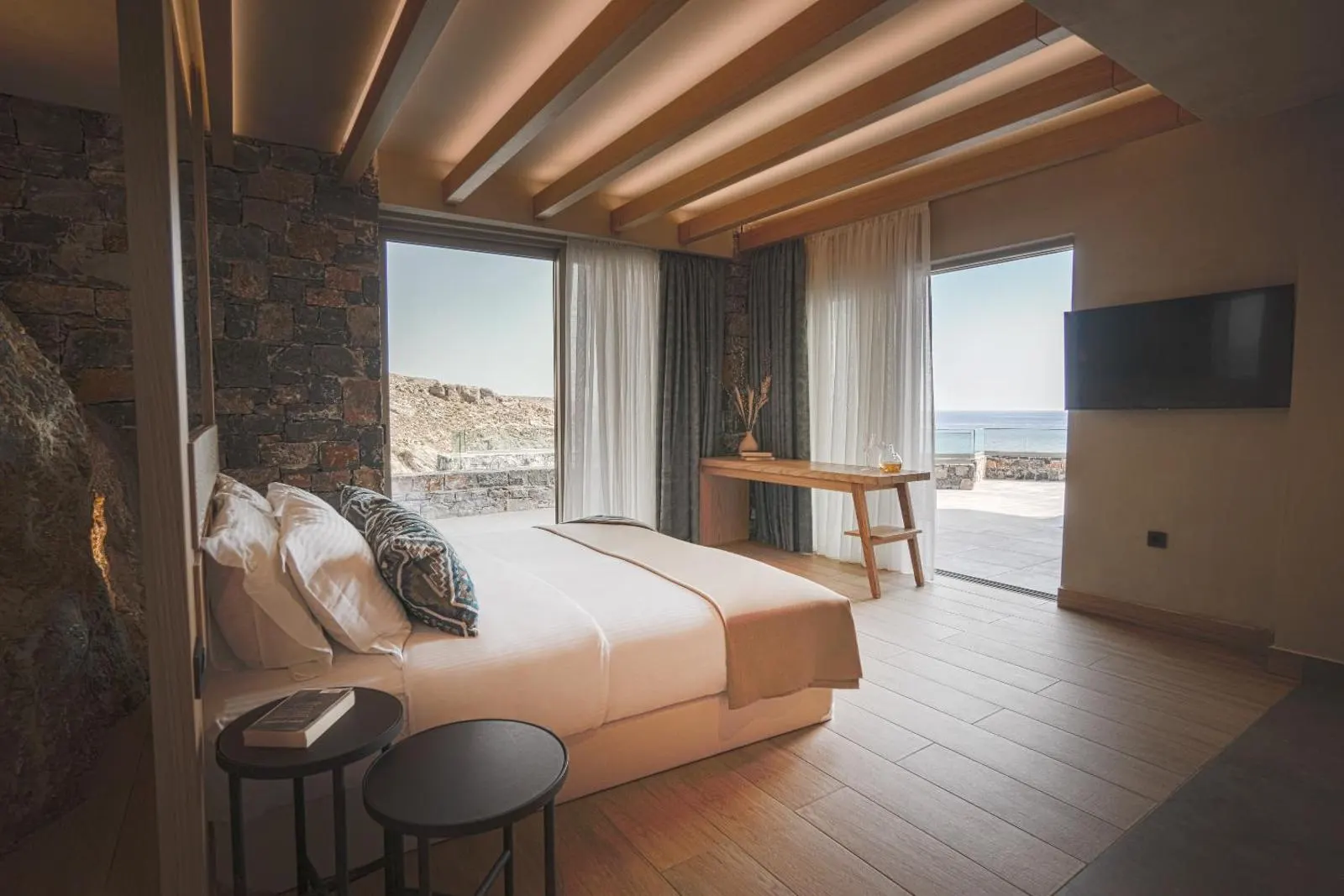 Bedroom with wooden beams and sea view window