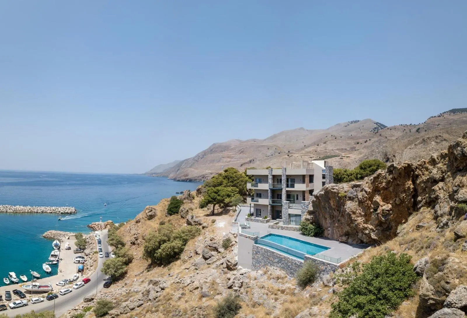 Aerial view of hotel perched on coastal cliff