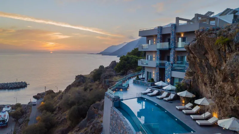 Sunset view over pool and coastline at hotel