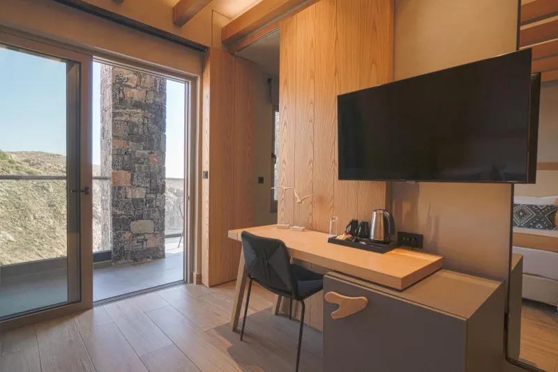Desk area with TV and balcony access