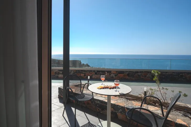 Balcony table with wine overlooking the sea