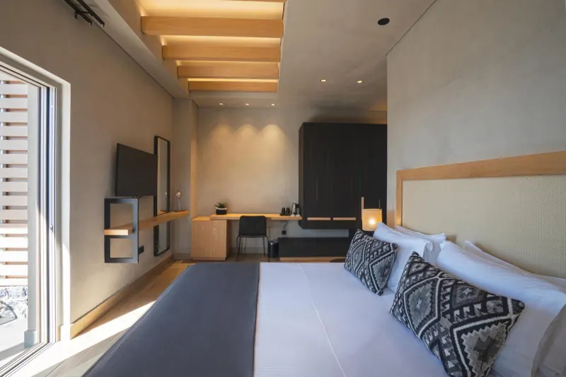 Bedroom with desk and wooden ceiling beams