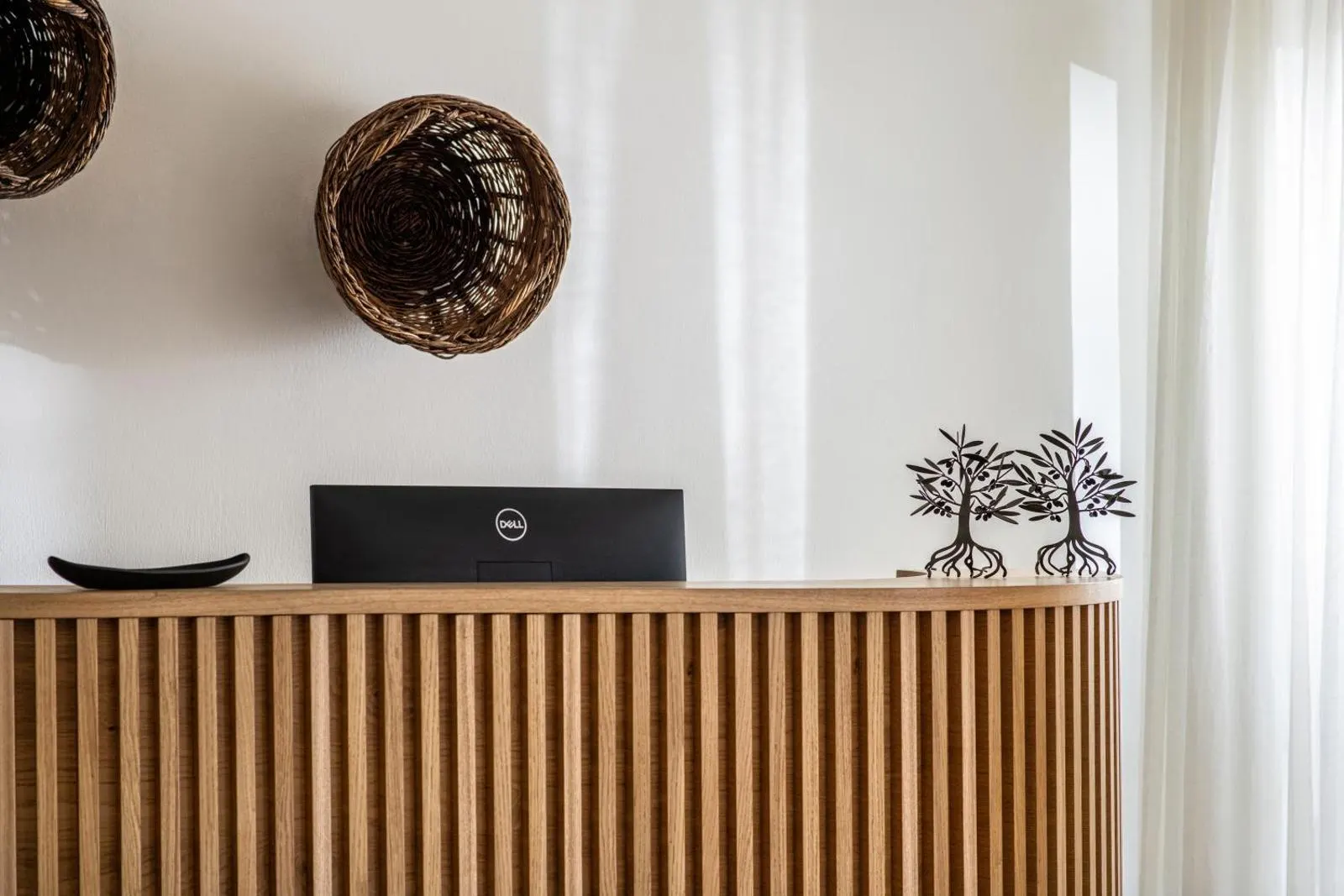 Wooden sideboard with decorative baskets and sculptures