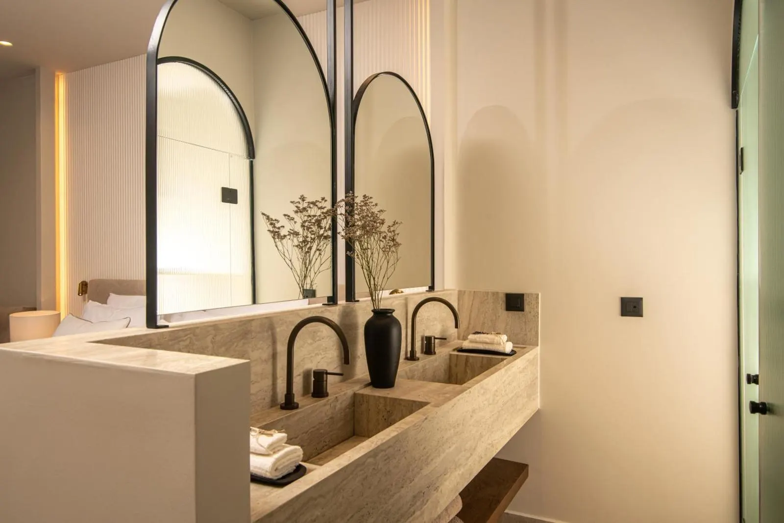 Modern bathroom with arched mirrors and stone sinks