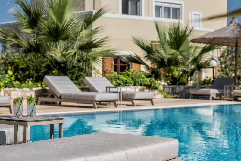Poolside loungers surrounded by palm trees