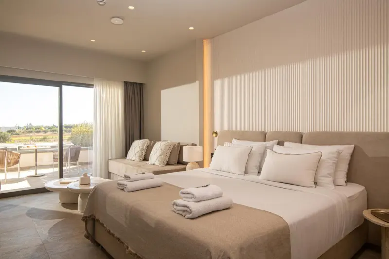 Elegant bedroom with beige tones and balcony