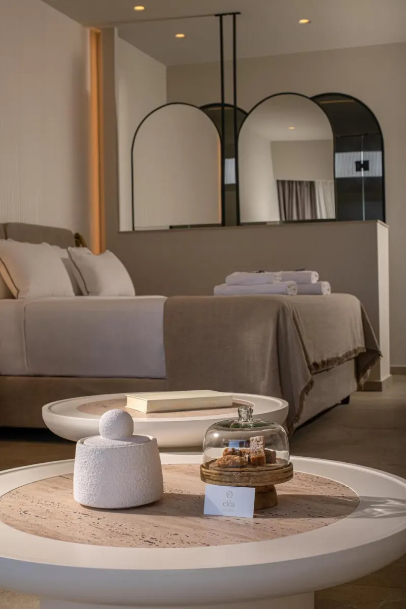 Bedroom with round table and arched mirrors