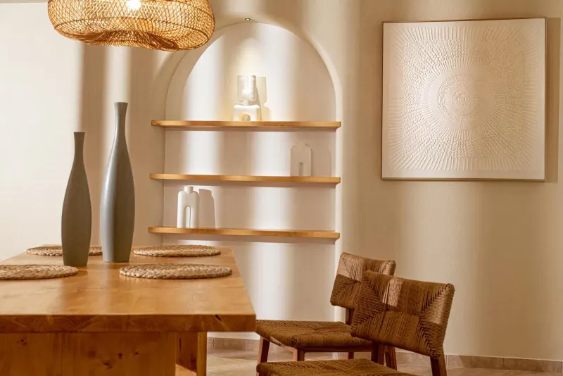 Dining nook with wooden table and arched shelving