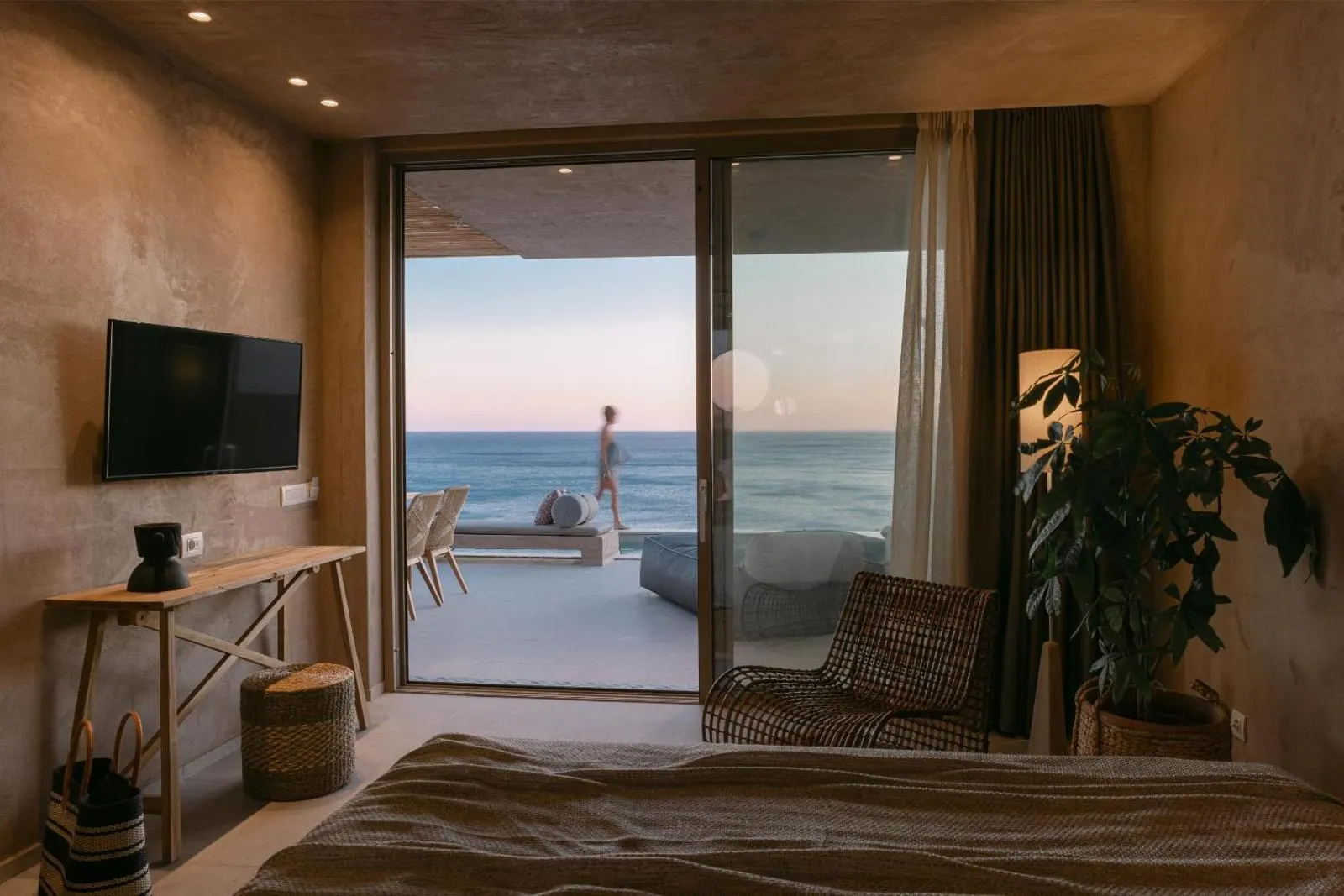 Bedroom with sliding doors opening to sea view