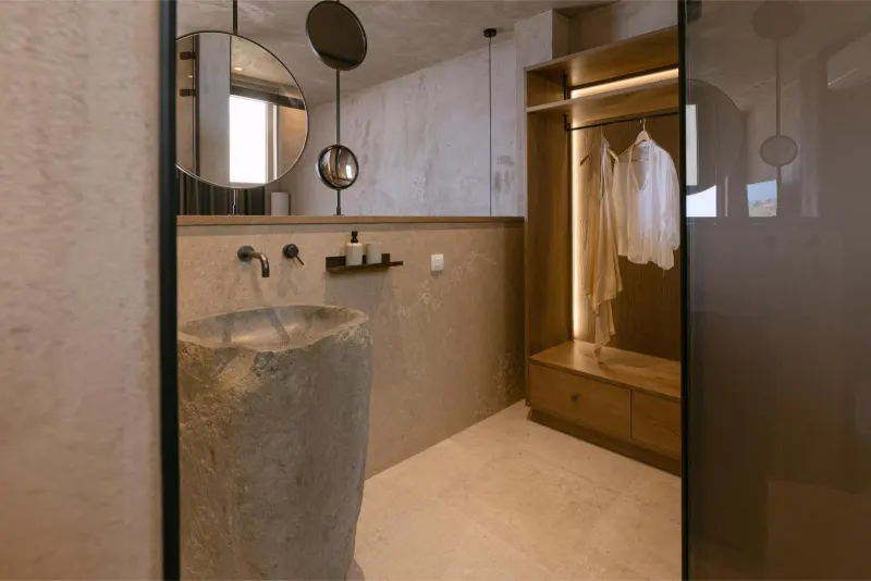Bathroom with stone sink and round mirrors