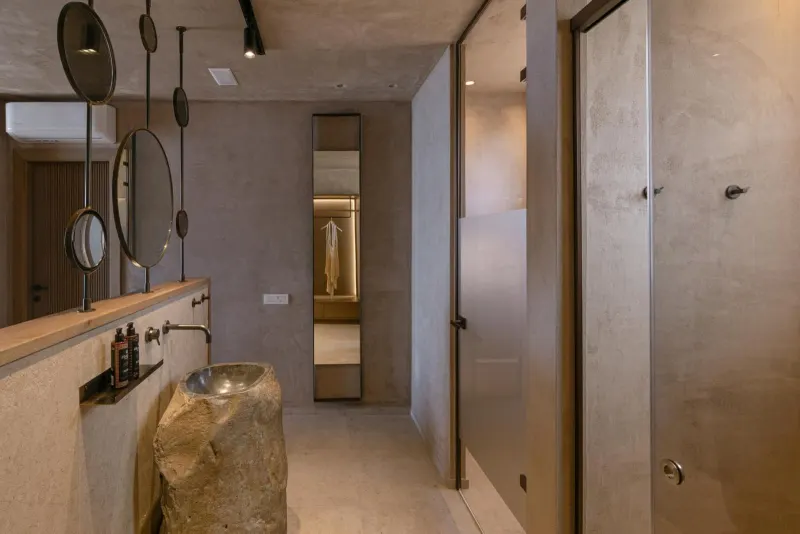 Hallway with mirrors leading to bathroom