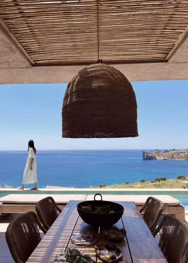 Woman walking on terrace overlooking sea view