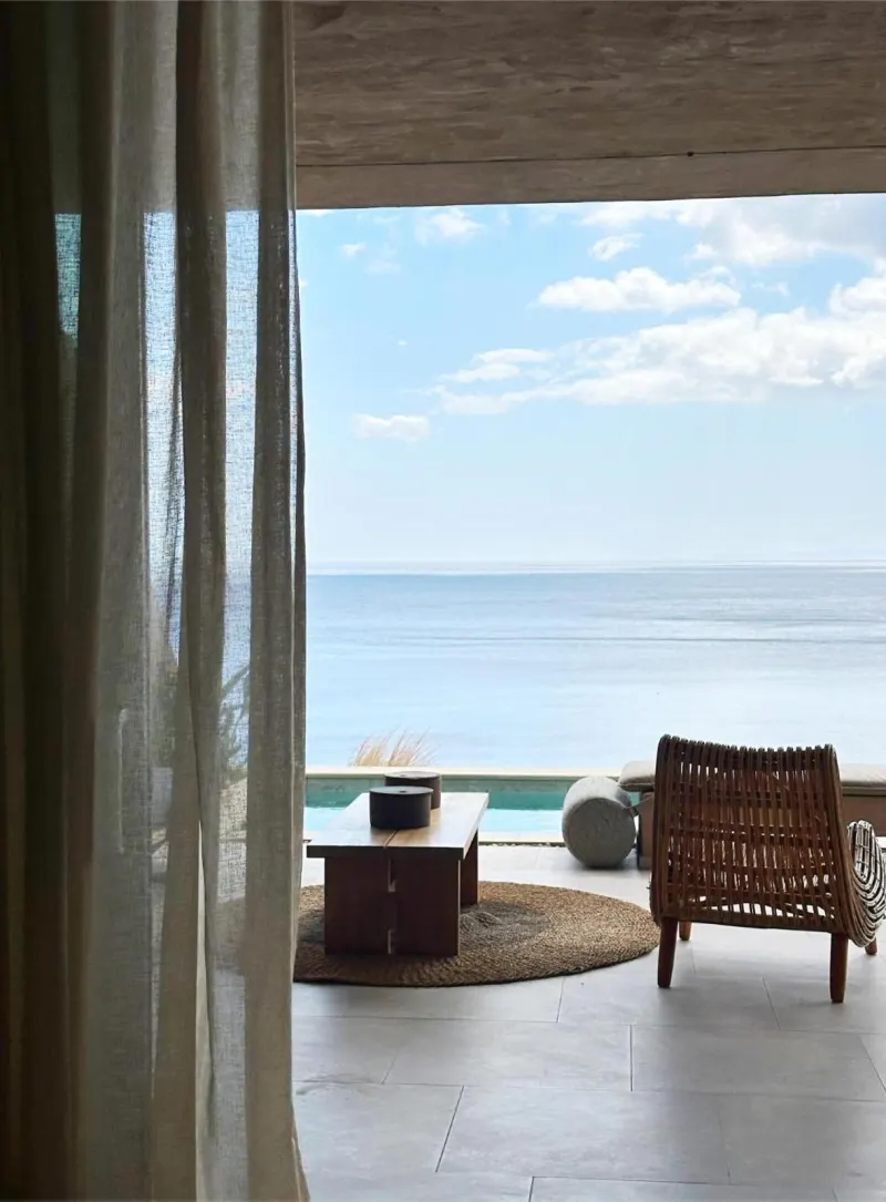 Sheer curtain framing ocean view from lounge
