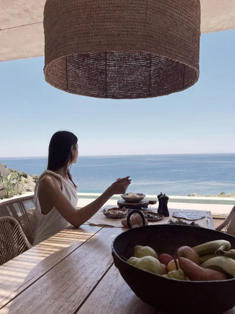Woman enjoying breakfast with ocean view