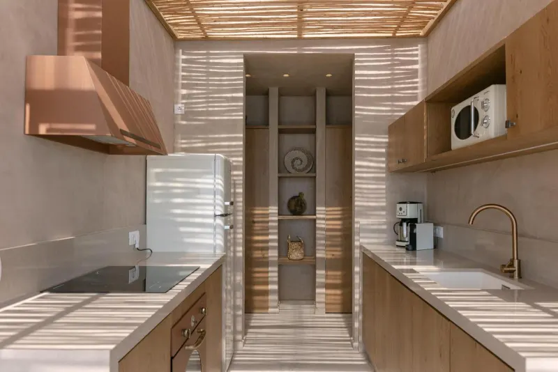 Modern kitchen with wood cabinetry and copper hood