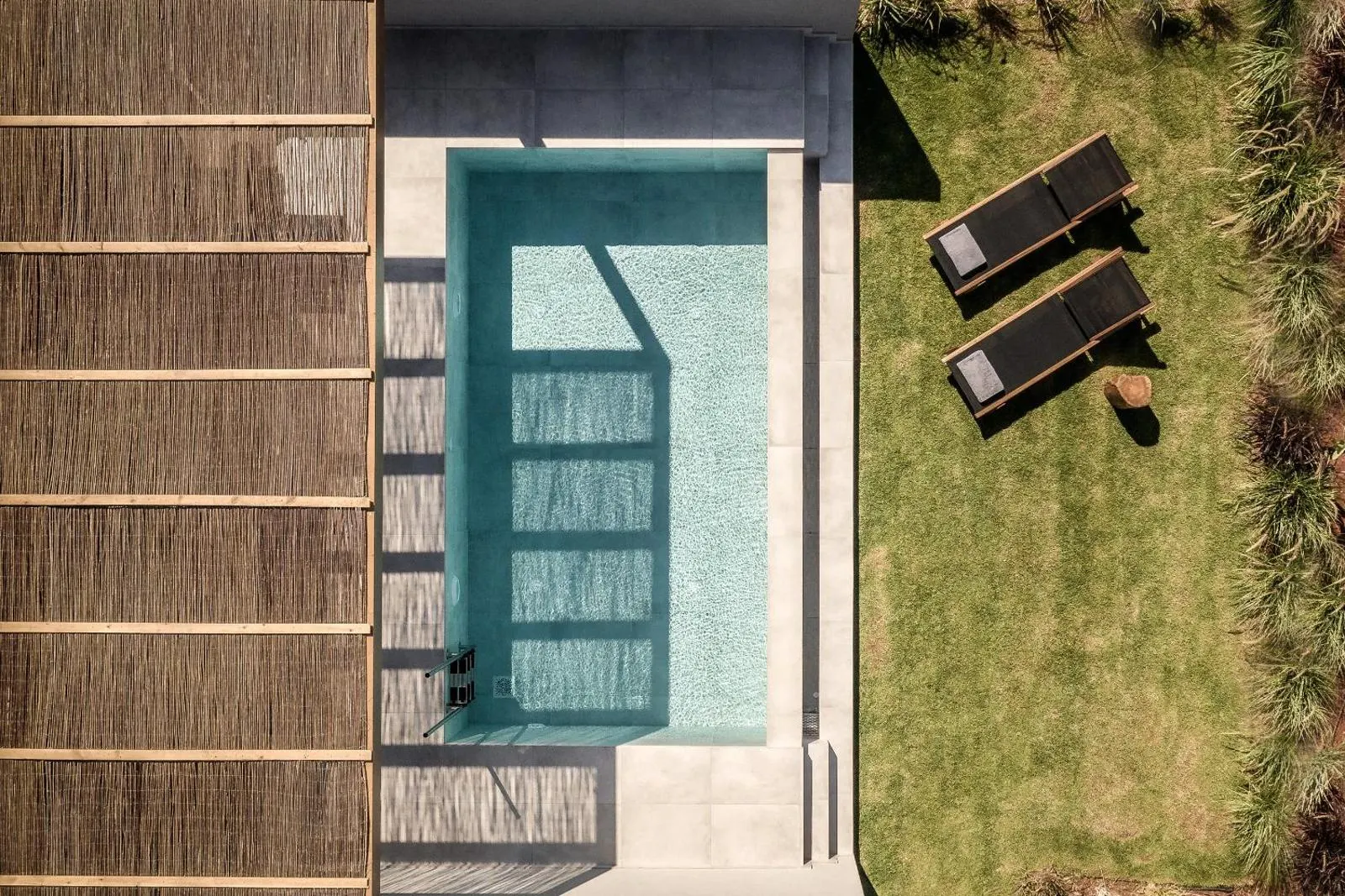 Aerial view of pool and lounge chairs on lawn