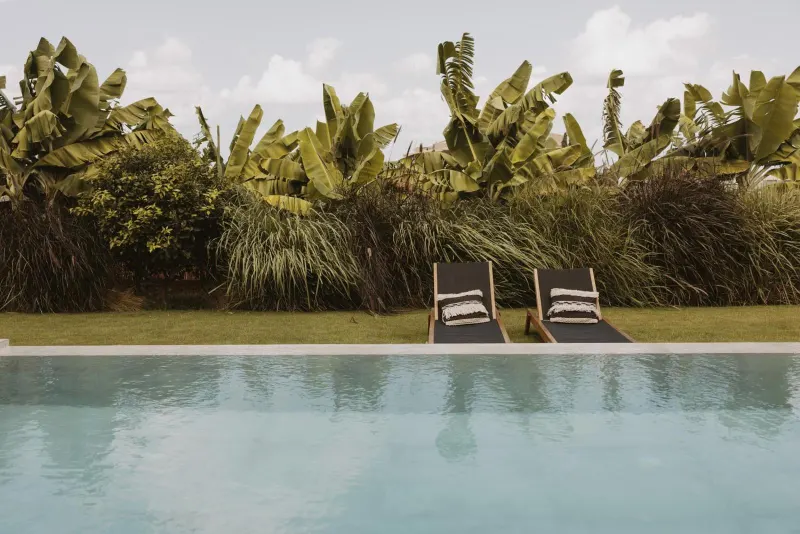 Pool edge overlooking lush tropical garden