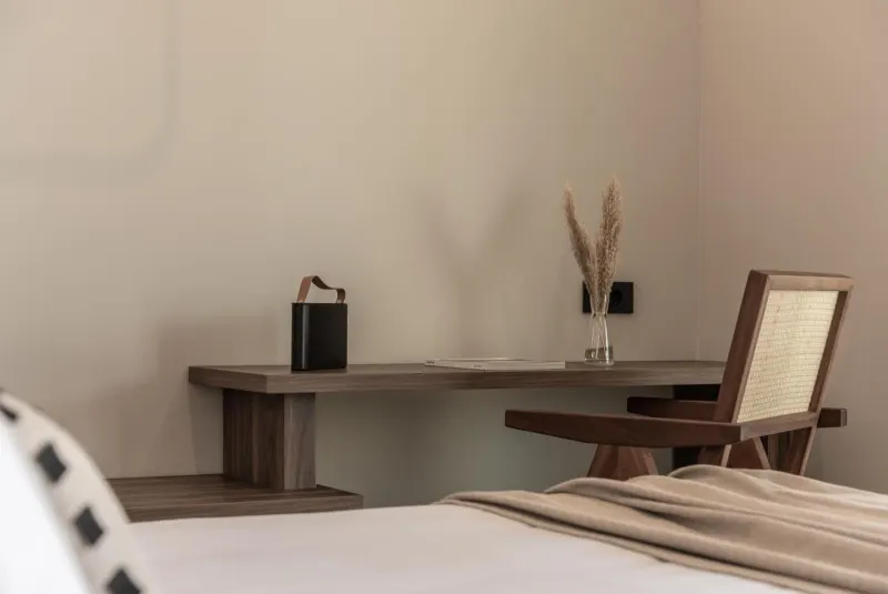 Wooden desk and chair in bedroom corner