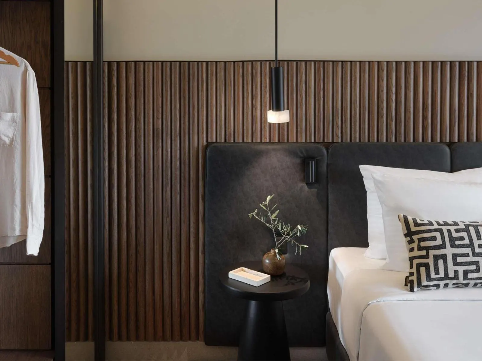 Bedside table with lamp and small plant detail