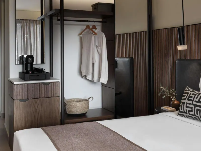 Open closet with hanging shirt and coffee station