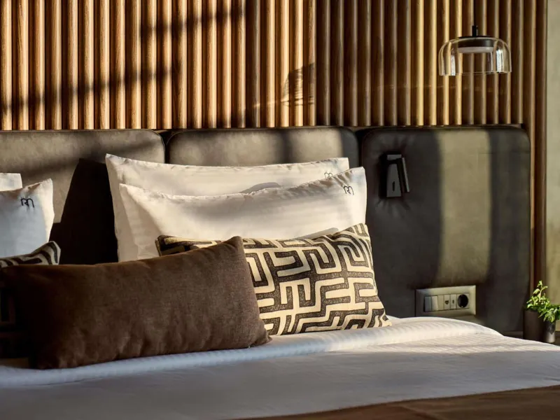 Close-up of bed pillows with patterned cushions