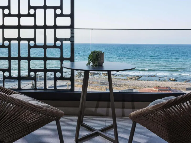 Balcony table and chairs overlooking the sea