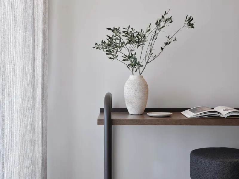 Console table with vase and olive branches