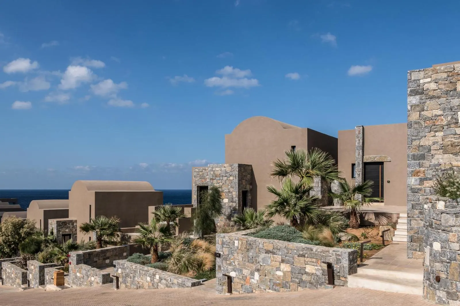 Stone and clay-toned villas surrounded by desert landscaping
