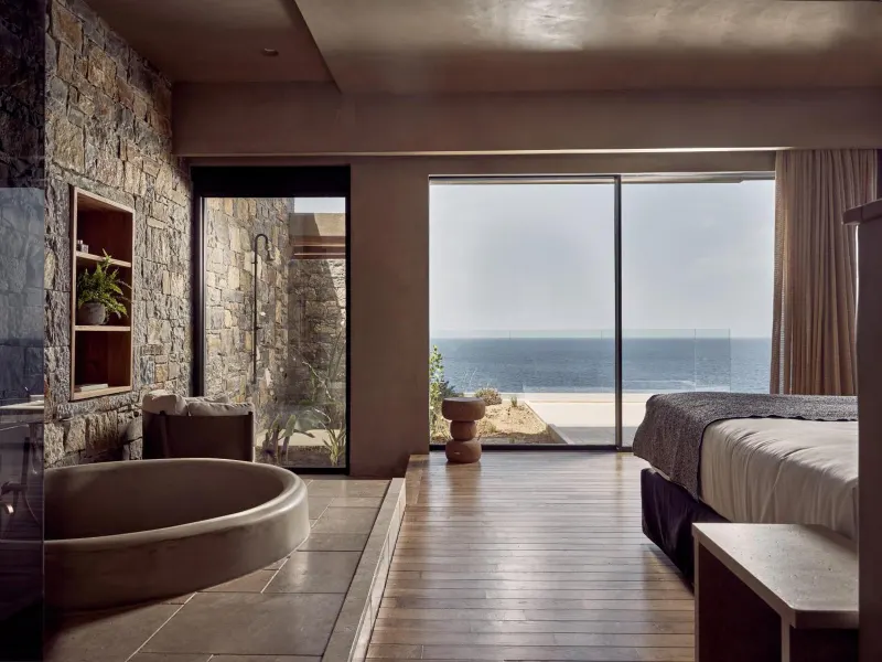 Bedroom with round soaking tub and ocean view
